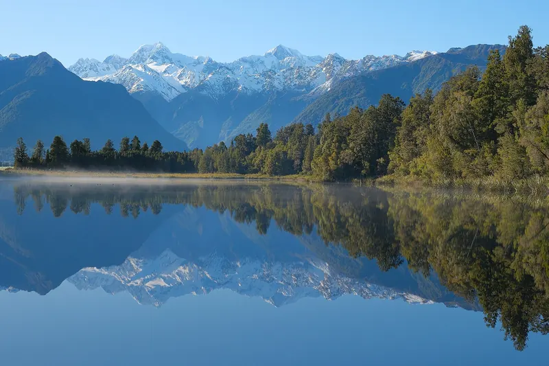 Lake Matheson's mirror reflection of Aoraki/Mount Cook and Mount Tasman