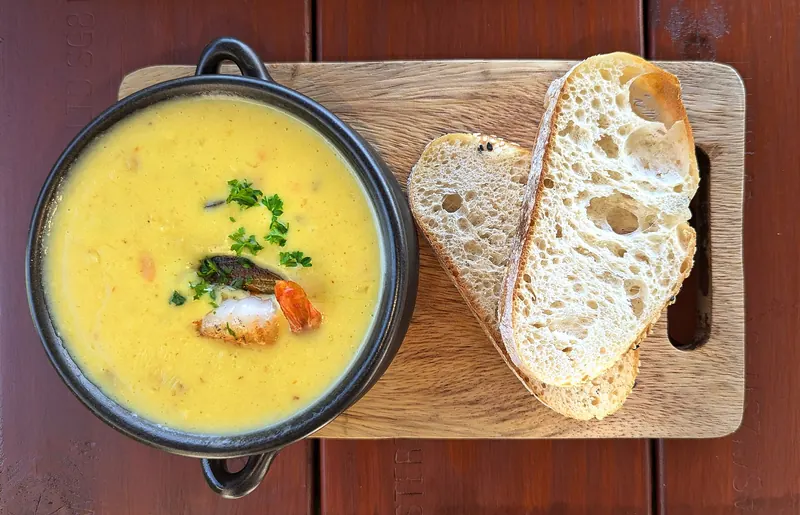A bowl of New Zealand seafood chowder with bread