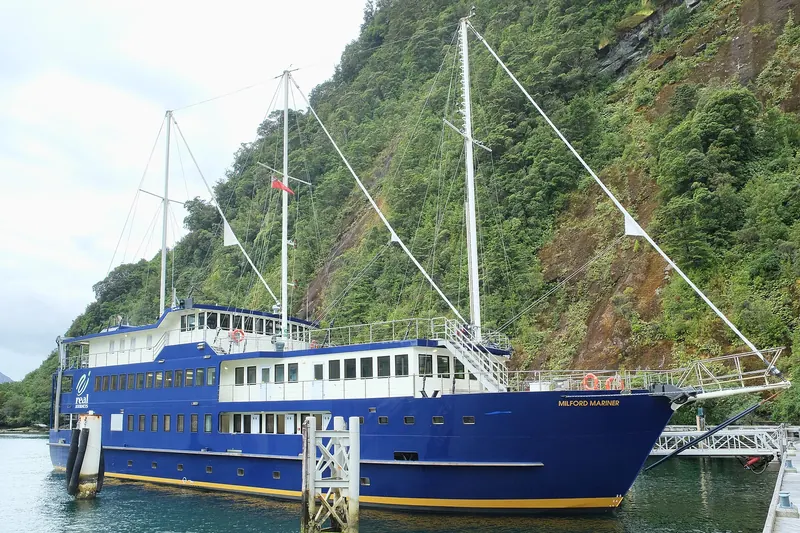 A cruise boat docked at the Milford Sound wharf