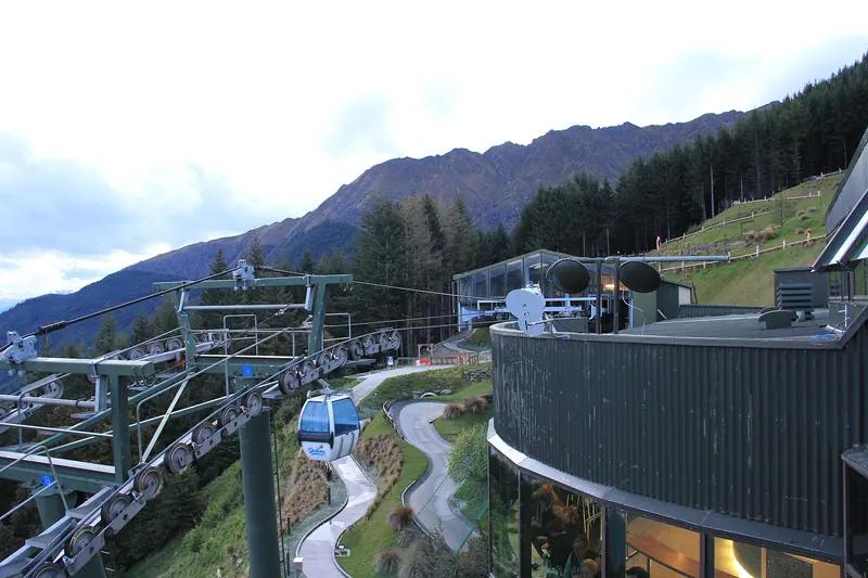 The Skyline Gondola climbing above Queenstown with lake and mountain views