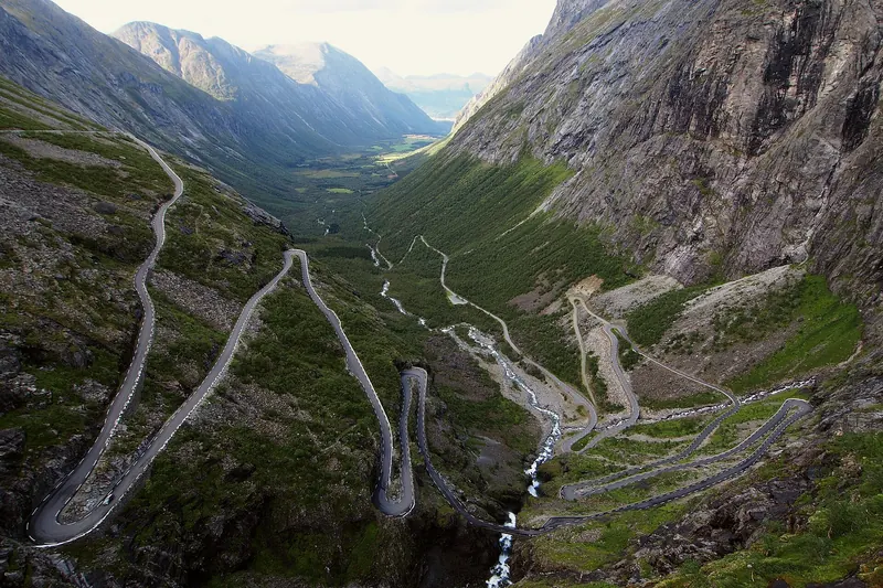 A car navigating the hairpin turns of the Trollstigen mountain road