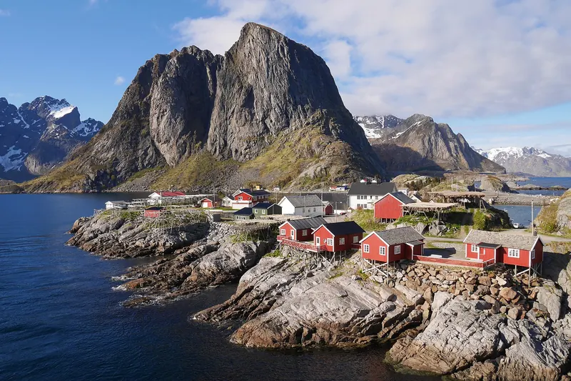 Red fishing cabins in Hamnøy beneath the Lofoten peaks