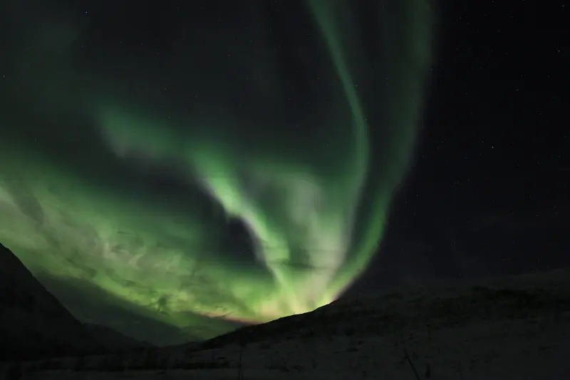 The aurora borealis over the landscape near Tromsø
