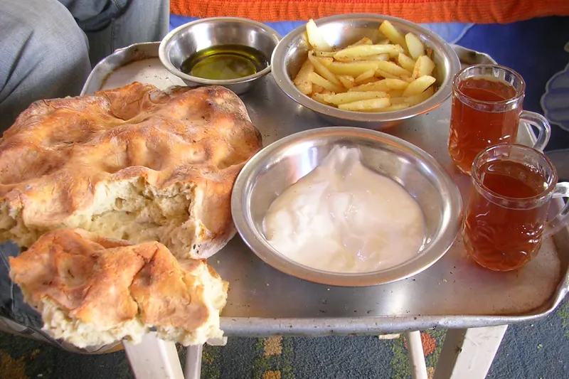 A Palestinian breakfast spread with olives, labneh, hummus, eggs and bread