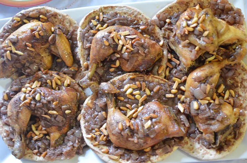 A platter of musakhan, roast chicken with onions and sumac on flatbread