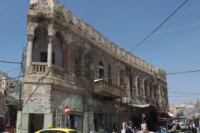 A stone street in the Old City of Hebron with shops and arches