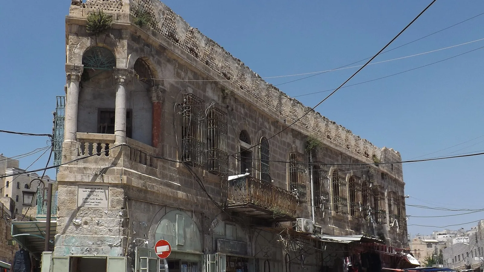 A stone street in the Old City of Hebron with shops and arches