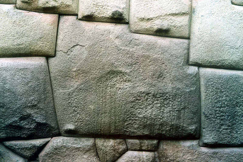 Visitors examining the Twelve-Angled Stone in Cusco