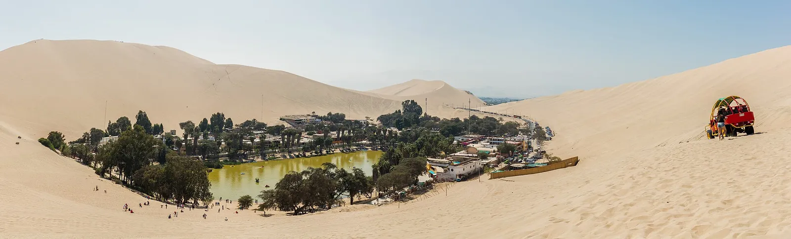The palm-fringed oasis of Huacachina surrounded by desert dunes
