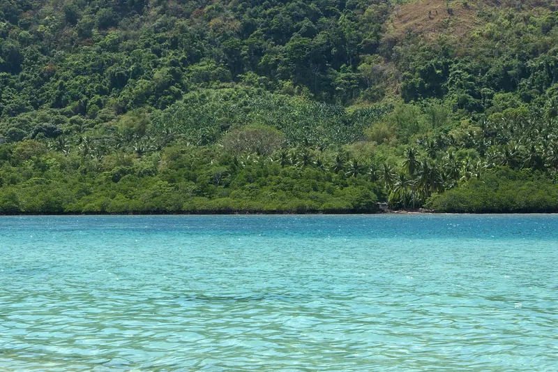 A desert tropical island with white sand and clear water in El Nido Bay, Palawan