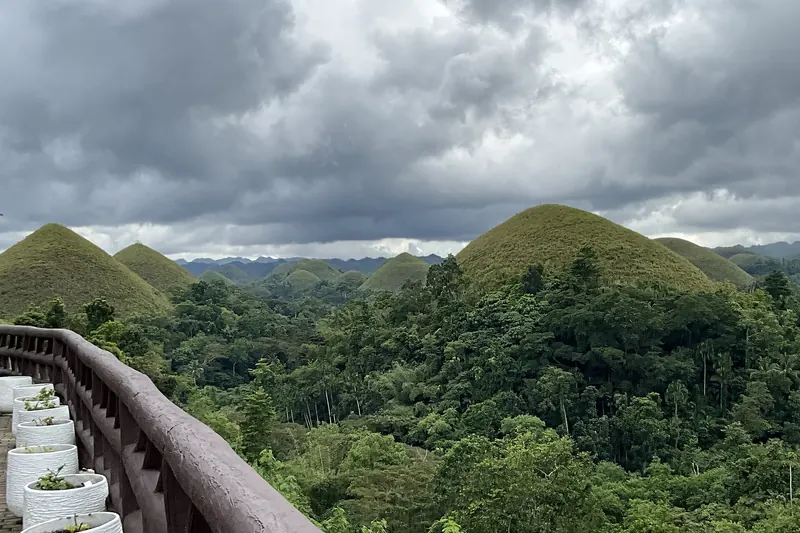 Rounded green Chocolate Hills seen from the viewing deck at Carmen