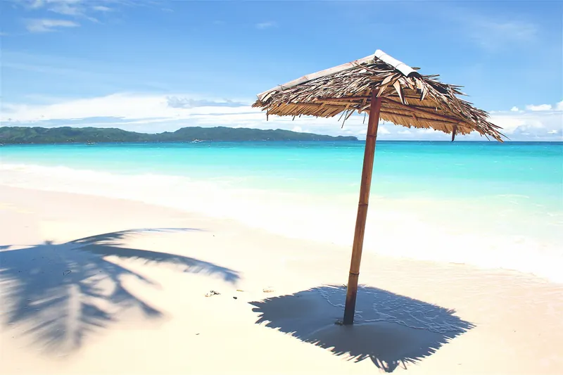 Boracay's White Beach on a bright day with sunbathers and boats