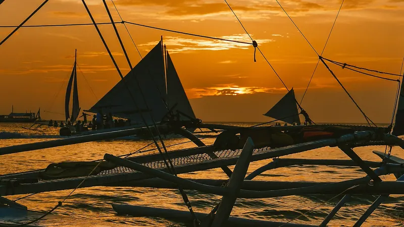 Paraw sailboats on the water at Boracay sunset