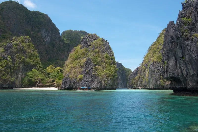 A limestone island covered in greenery in Bacuit Bay