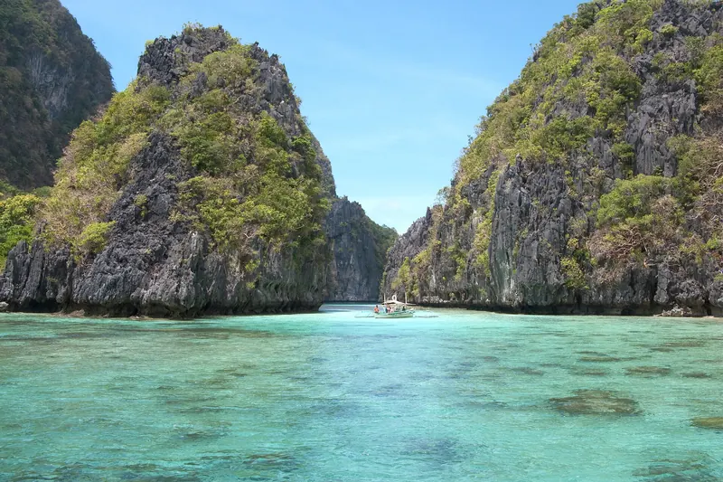 A turquoise island lagoon among limestone cliffs in Bacuit Bay, El Nido