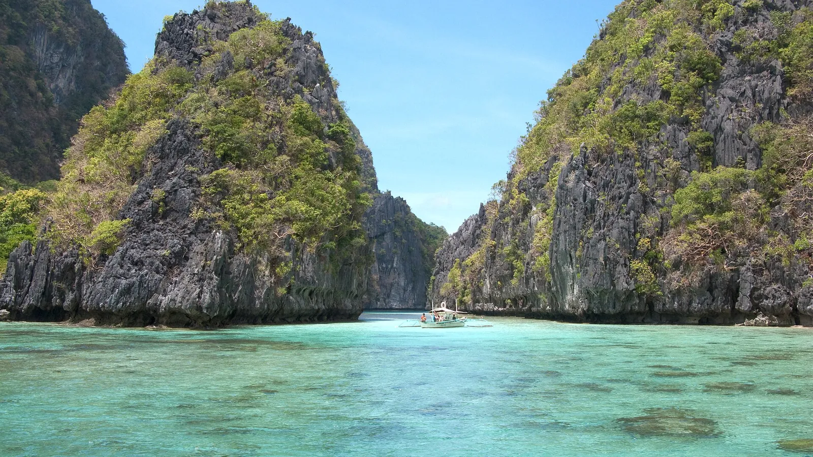 A turquoise island lagoon among limestone cliffs in Bacuit Bay, El Nido