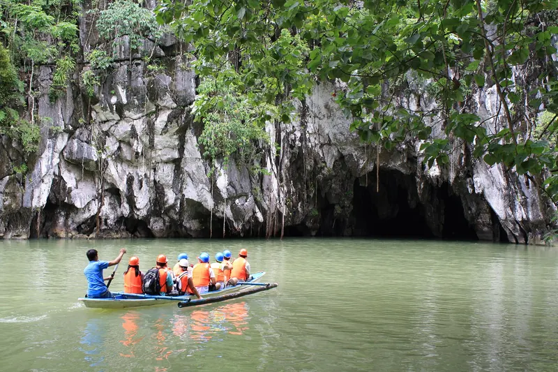 The entrance of the Puerto Princesa Underground River with a boat in the lagoon