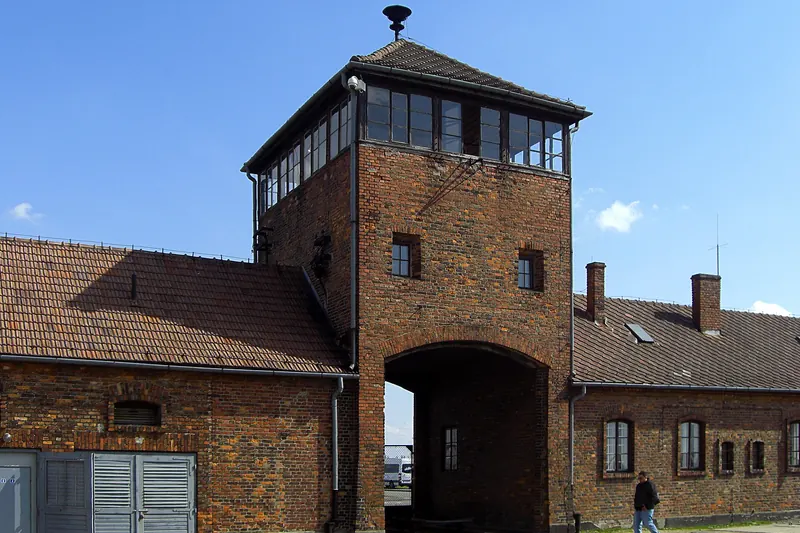 The gatehouse of Auschwitz II-Birkenau with railway tracks entering