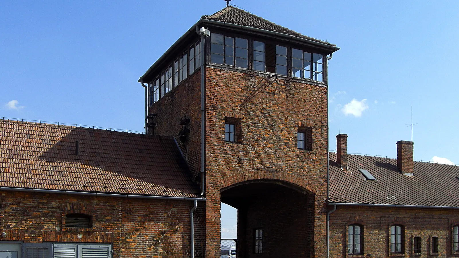 The gatehouse of Auschwitz II-Birkenau with railway tracks entering