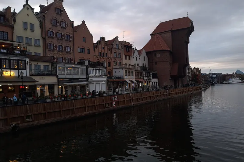 The medieval port crane on the Motława waterfront at evening