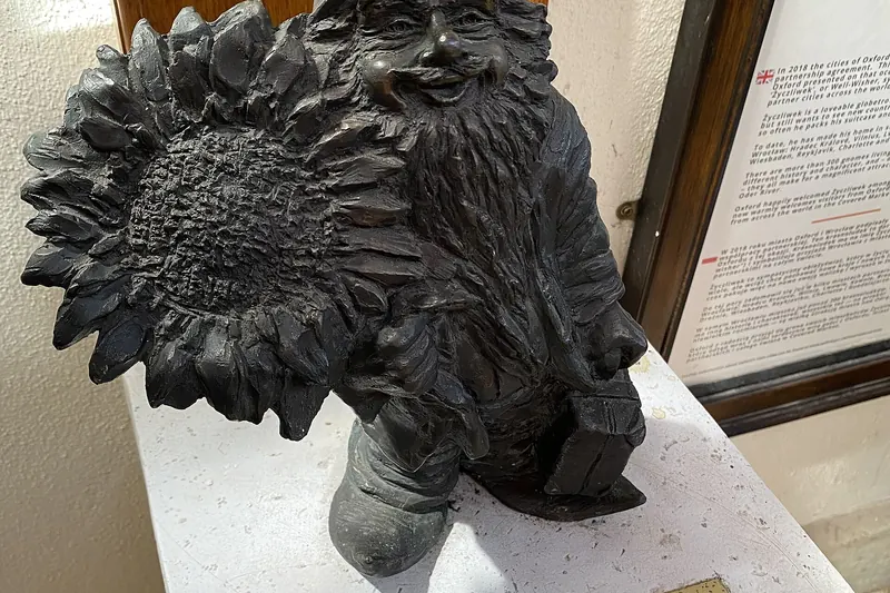 A small bronze gnome statue in a Wrocław street