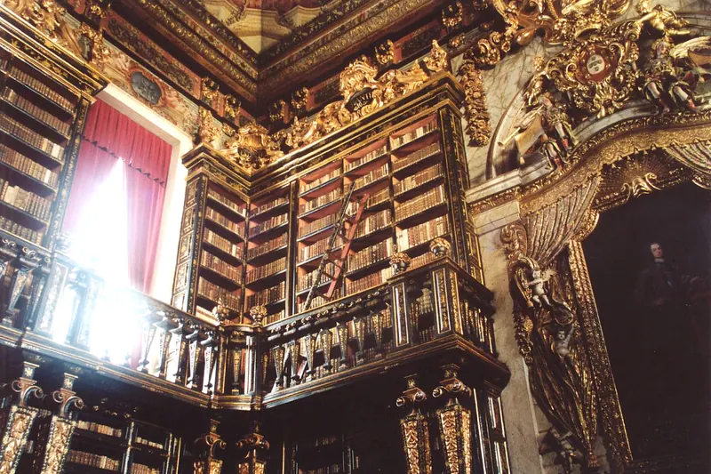The gilded Baroque interior of the Biblioteca Joanina at the University of Coimbra