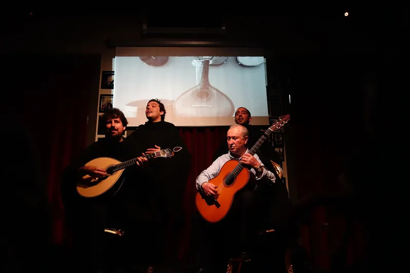 Musicians performing fado de Coimbra in traditional academic dress