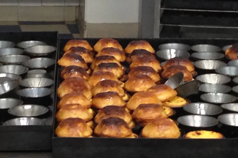 Fresh pastéis de nata, Portugal's custard tarts, dusted with cinnamon