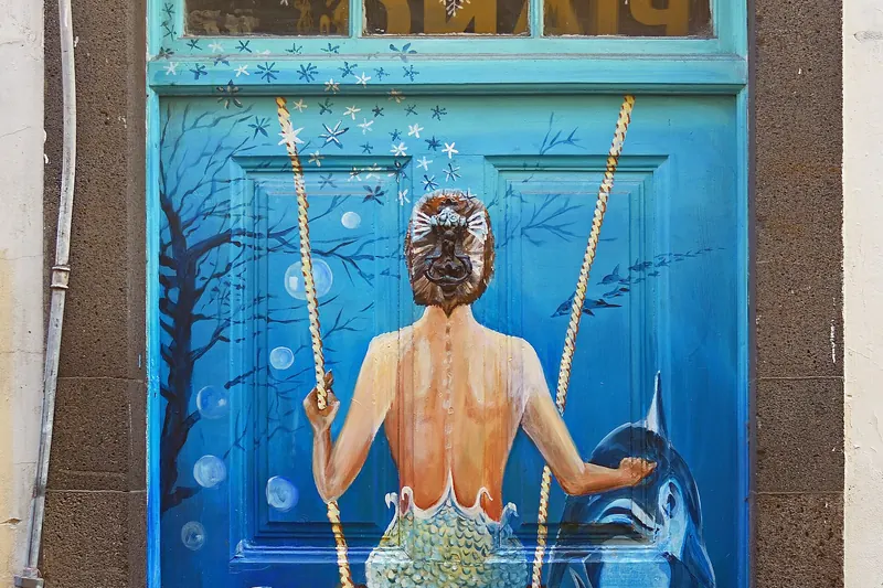 A colourfully painted wooden door as part of Funchal's Art of Open Doors project in the Zona Velha