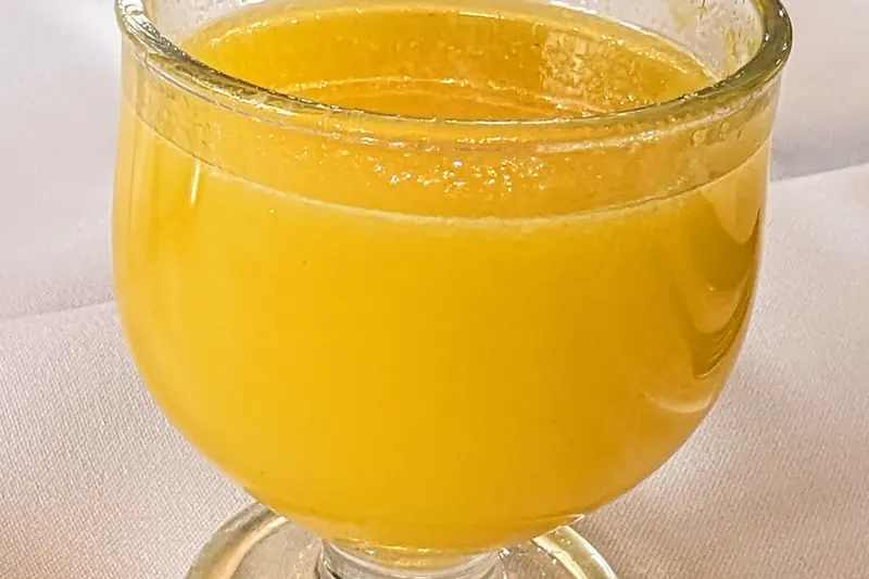 A glass of poncha, Madeira's traditional cocktail of sugarcane spirit, honey and citrus