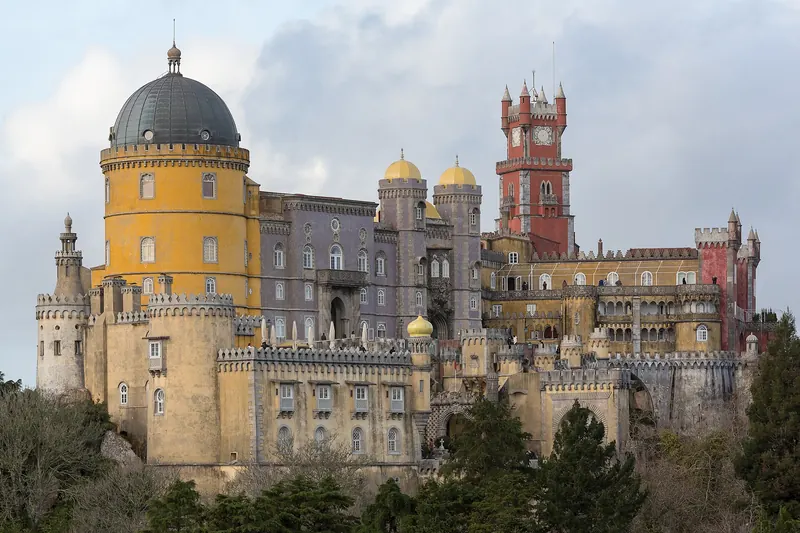Pena Palace's colourful towers rising above the forested hills of Sintra