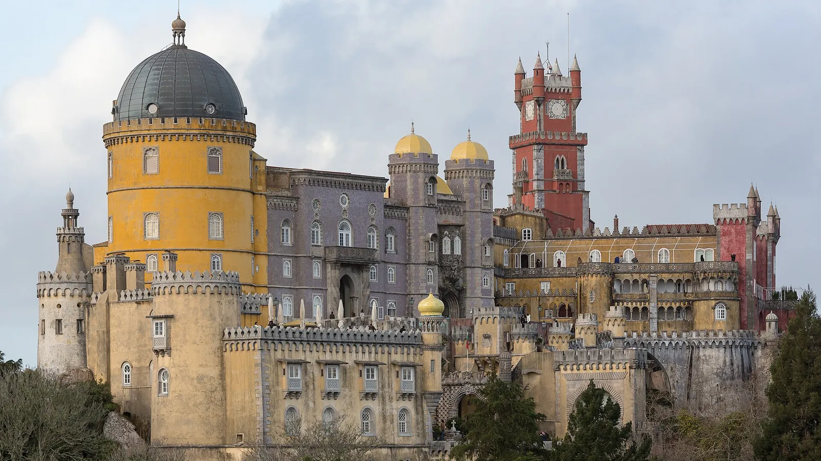 Pena Palace's colourful towers rising above the forested hills of Sintra