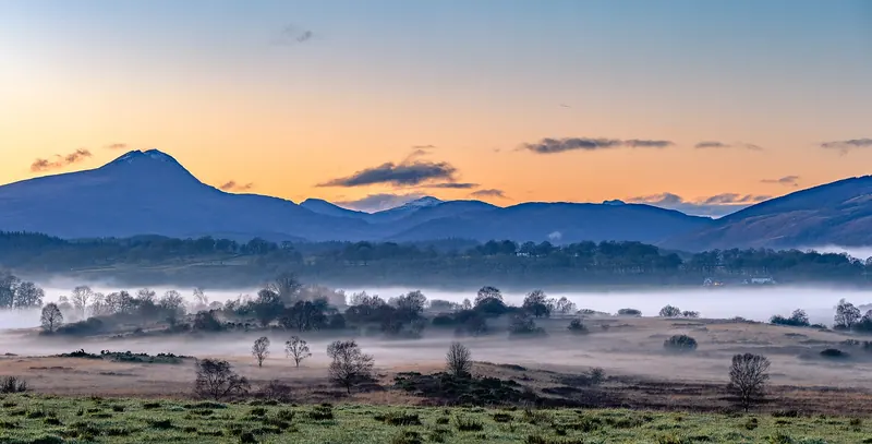 The wooded hills of the Trossachs at sunset