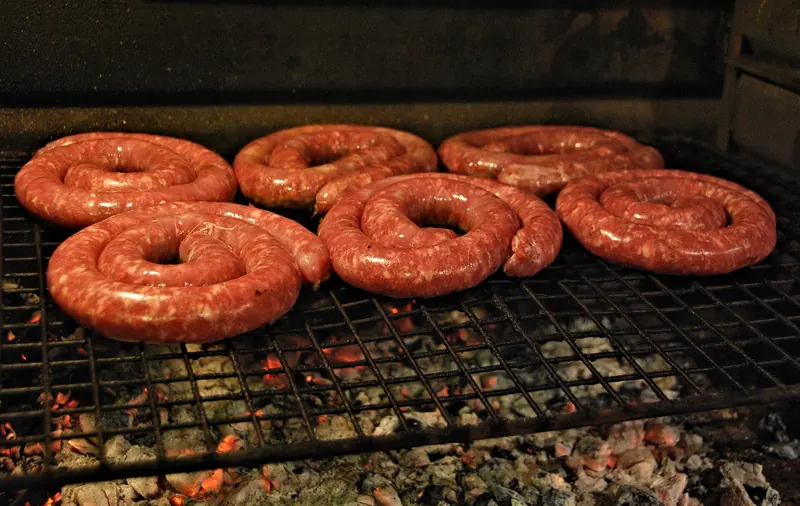 Boerewors sausages grilling on a South African braai
