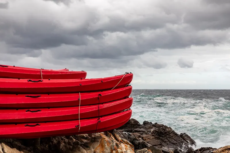 Kayaks resting on the rocky coast of Tsitsikamma National Park