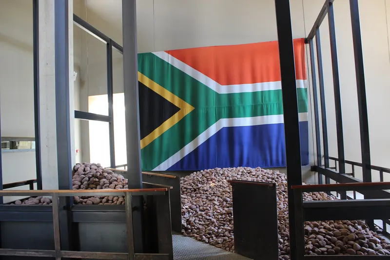 The entrance to the Apartheid Museum in Johannesburg with concrete pillars and a memorial