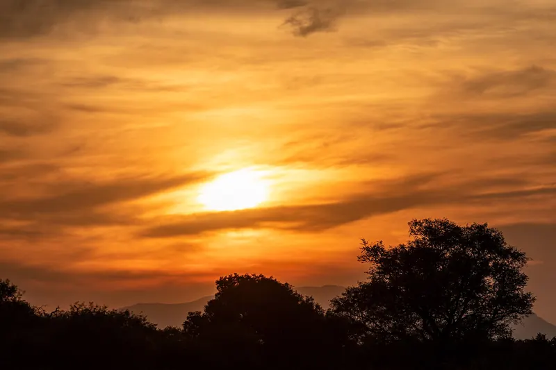 A sunset over the bushveld of a private game reserve near Kruger