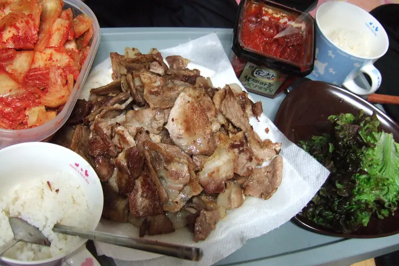 Pork belly grilling at the table for Korean barbecue