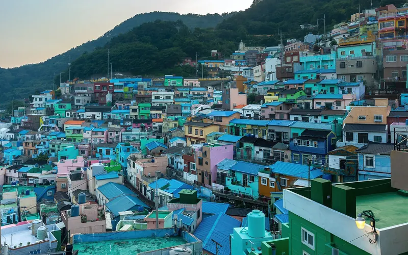 Colourful houses in Gamcheon Culture Village on a hillside at sunset