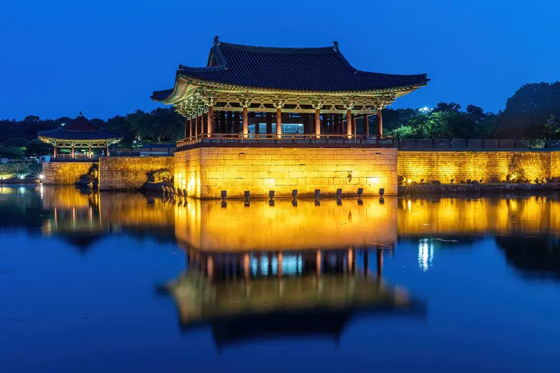 Donggung Palace pavilions reflected in Wolji Pond at blue hour