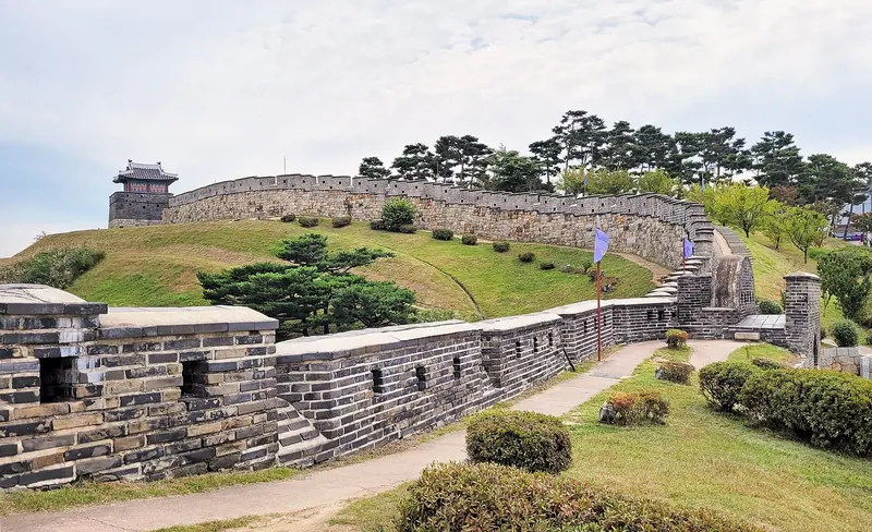 The curving wall of Hwaseong Fortress with a watchtower