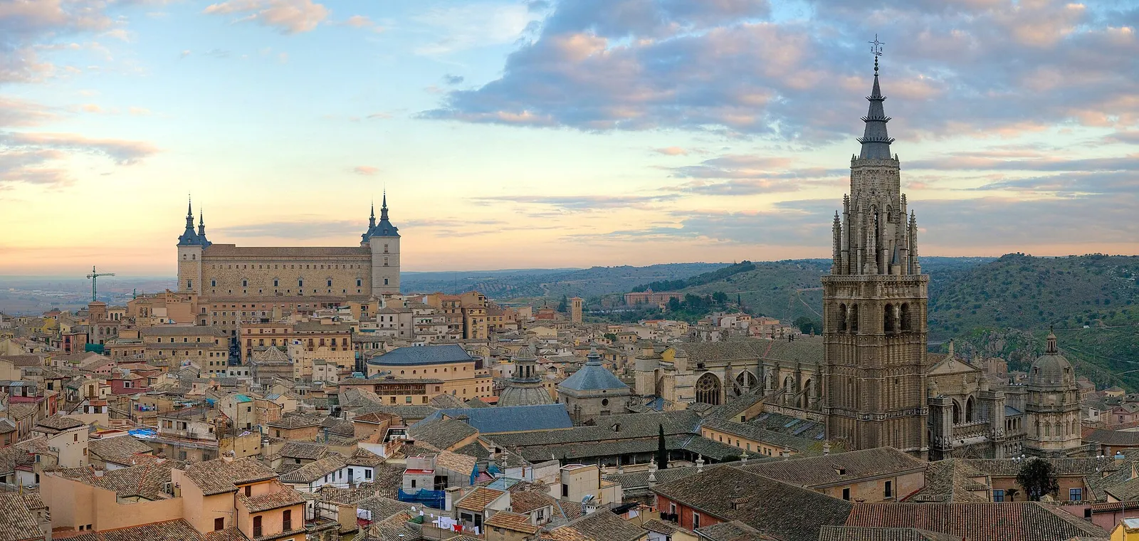 The stacked skyline of Toledo above the Tagus river at dusk