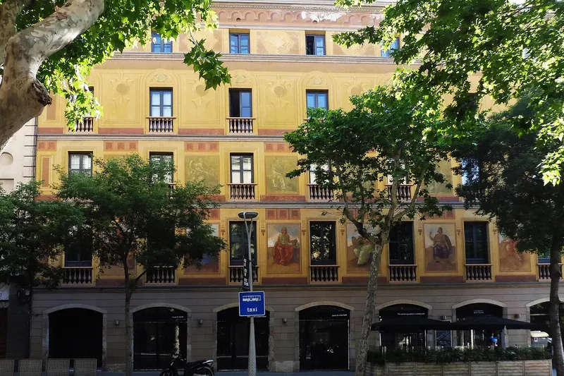 A painted Eixample facade above the street in Barcelona