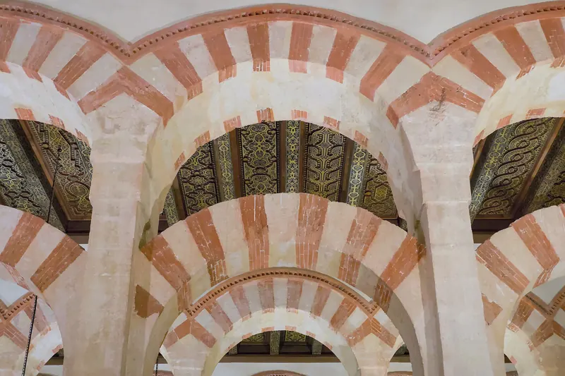 The forest of columns and red-and-white striped double arches inside the Mezquita of Córdoba