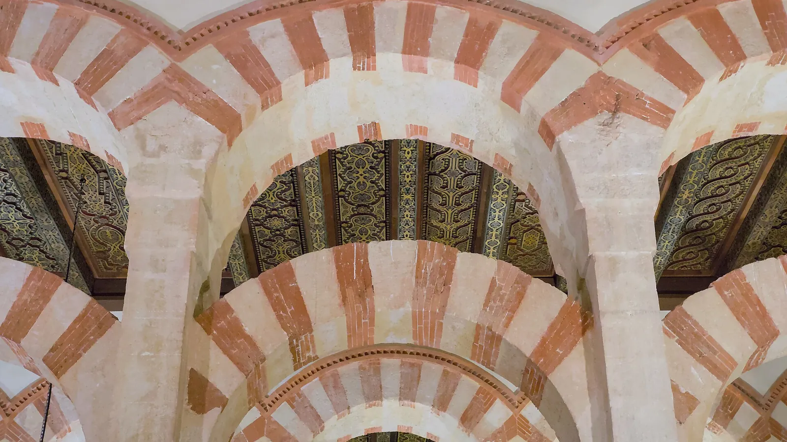 The forest of columns and red-and-white striped double arches inside the Mezquita of Córdoba