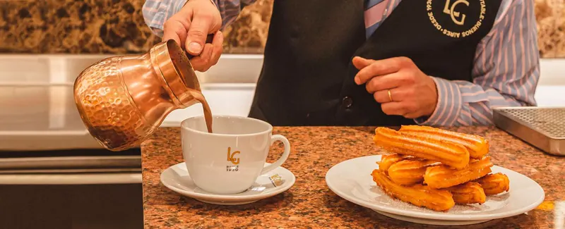 Churros beside a cup of thick chocolate