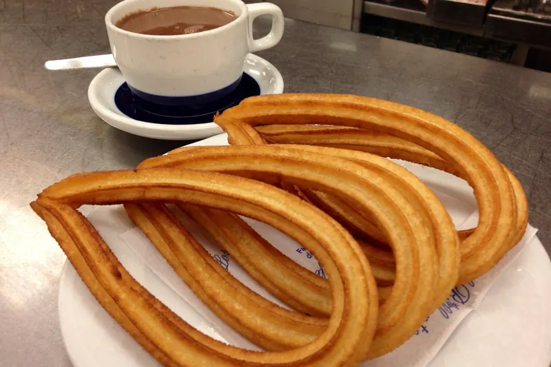 Churros with a cup of thick drinking chocolate