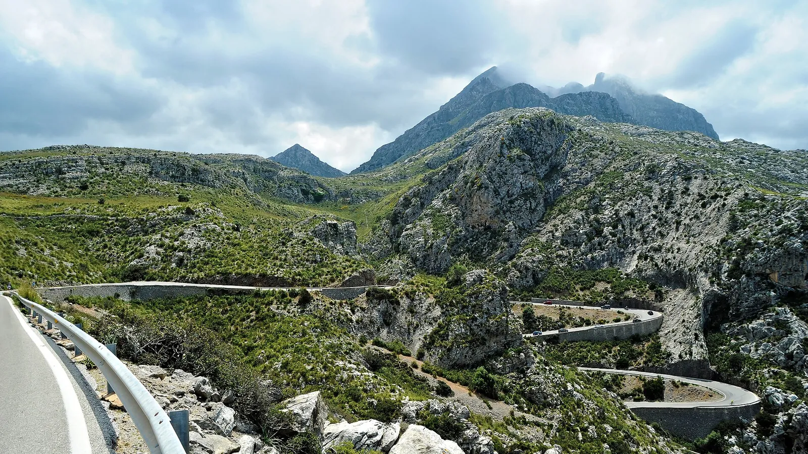 Terraced slopes and pine-covered ridges of the Serra de Tramuntana falling towards the sea in Mallorca