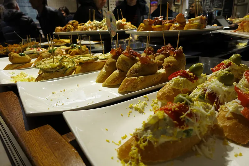 Pintxos on bread arranged along the bar
