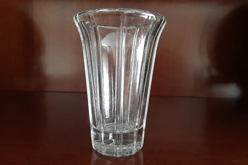 A glass of txakoli poured from a height